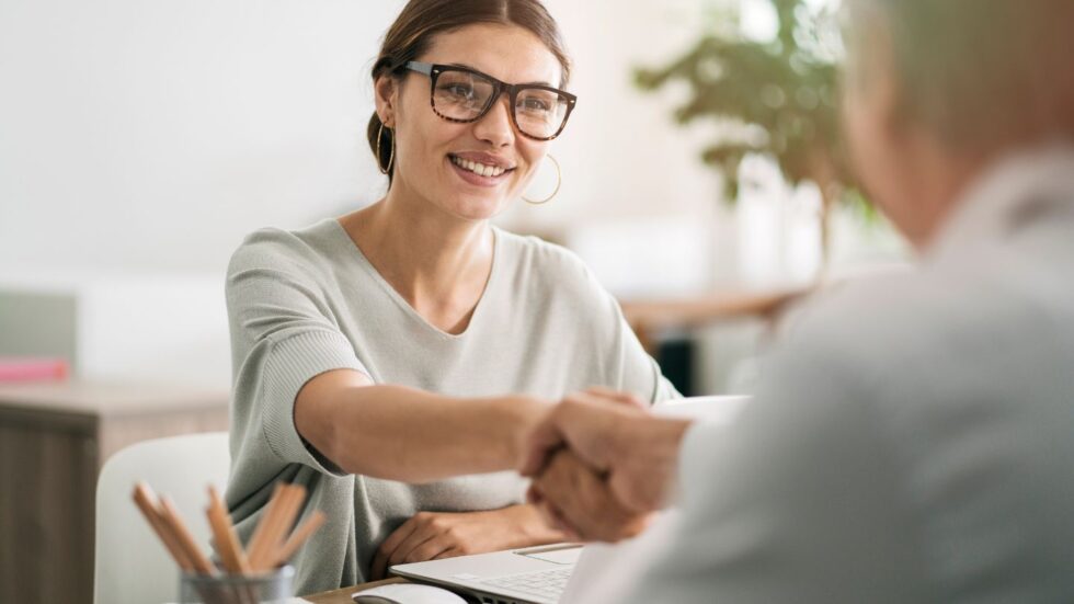 An Insurance Agent Handshaking Client